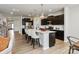 Bright kitchen with dark cabinets, a white countertop island, and stainless steel appliances at 8000 Millbridge Pkwy, Waxhaw, NC 28173