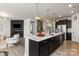 Well-appointed kitchen with a large island, stainless steel appliances, and open layout to living area at 8000 Millbridge Pkwy, Waxhaw, NC 28173