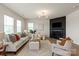 Bright living room with fireplace and abundant natural light, perfect for relaxation and entertaining at 8000 Millbridge Pkwy, Waxhaw, NC 28173