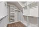 Spacious walk-in closet featuring custom shelving and ample storage space on a wood floor at 8000 Millbridge Pkwy, Waxhaw, NC 28173