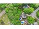 Aerial perspective highlighting a home nestled among mature trees, featuring a pool and patio at 8214 Coristar Pl, Huntersville, NC 28078