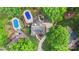 Aerial view of a home with a pool, lush landscaping, and a spacious backyard retreat at 8214 Coristar Pl, Huntersville, NC 28078