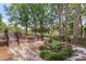 Inviting backyard with a stone waterfall, wooden deck, and charming landscaping at 8214 Coristar Pl, Huntersville, NC 28078