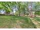 Large grassy backyard with scattered trees and outbuildings at 8214 Coristar Pl, Huntersville, NC 28078