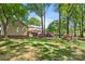 Spacious backyard with mature trees, a shed, and colorful azalea bushes at 8214 Coristar Pl, Huntersville, NC 28078