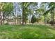 Expansive backyard with mature trees and a storage shed, offering ample space at 8214 Coristar Pl, Huntersville, NC 28078