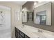 Well-lit bathroom featuring a double sink vanity with contemporary mirrors and a shower-tub combo at 8214 Coristar Pl, Huntersville, NC 28078