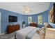 Cozy bedroom with a ceiling fan, dresser, and natural light from windows, a relaxing retreat at 8214 Coristar Pl, Huntersville, NC 28078