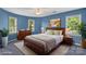 Comfortable bedroom featuring a ceiling fan and natural light from multiple windows at 8214 Coristar Pl, Huntersville, NC 28078