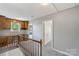 Bright hallway with hardwood railing and built-in wood desk, offering style and functionality at 8214 Coristar Pl, Huntersville, NC 28078