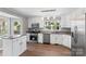 Bright kitchen with stainless steel appliances, granite countertops, and wood-look floors at 8214 Coristar Pl, Huntersville, NC 28078