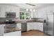 Bright kitchen with stainless steel appliances, granite countertops, and wood-look floors at 8214 Coristar Pl, Huntersville, NC 28078