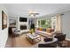 Stylish living room with a fireplace, neutral colors, contemporary furnishings and large window at 8214 Coristar Pl, Huntersville, NC 28078