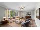 Inviting living room boasts neutral colors, hardwood floors, modern decor, and large picture window at 8214 Coristar Pl, Huntersville, NC 28078