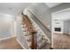 Inviting foyer featuring staircase with hardwood railing, gray walls and hardwood floors at 8214 Coristar Pl, Huntersville, NC 28078