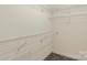 Spacious walk-in closet with plenty of shelving units, perfect for organized storage solutions at 8214 Coristar Pl, Huntersville, NC 28078