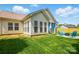 Spacious backyard view showcases the outdoor firepit, Adirondack chairs, and covered patio area with blue curtains at 8726 Castle Cliff Dr, Matthews, NC 28105