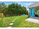 Lush backyard with a well-manicured lawn, stepping stones, and a covered patio with outdoor seating at 8726 Castle Cliff Dr, Matthews, NC 28105
