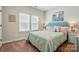 Cozy bedroom featuring plush bedding, decorative pillows, and soft lighting from bedside lamps at 8726 Castle Cliff Dr, Matthews, NC 28105