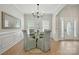 Cozy dining room with elegant chairs, glass table, and natural light from the windows at 8726 Castle Cliff Dr, Matthews, NC 28105