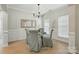 Bright dining room with elegant gray chairs, table set, and natural light streaming through windows at 8726 Castle Cliff Dr, Matthews, NC 28105