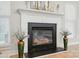 Elegant fireplace with decorative vases and a modern mantel design at 8726 Castle Cliff Dr, Matthews, NC 28105
