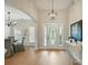 Elegant foyer with a decorative front door, high ceilings, chandelier, and hardwood floors at 8726 Castle Cliff Dr, Matthews, NC 28105