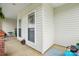 Relaxing front porch features comfortable seating, flower baskets, bright windows and neutral siding at 8726 Castle Cliff Dr, Matthews, NC 28105