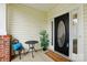 Charming front porch with decorative door, comfortable seating and stylish welcome mat at 8726 Castle Cliff Dr, Matthews, NC 28105
