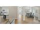 Spacious hallway connecting the kitchen, living room, and dining area, with sleek hardwood floors at 8726 Castle Cliff Dr, Matthews, NC 28105