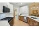 Well-lit kitchen featuring white cabinets, stainless steel appliances, and an eat-in breakfast bar at 8726 Castle Cliff Dr, Matthews, NC 28105