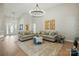 Spacious living room with hardwood floors, stylish seating, and a grand chandelier at 8726 Castle Cliff Dr, Matthews, NC 28105