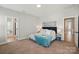 Comfortable main bedroom featuring carpeted floors, a king-sized bed, and access to a bathroom at 8726 Castle Cliff Dr, Matthews, NC 28105