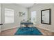 Bright office space featuring a stylish desk, world map art, and ample natural light from two large windows at 8726 Castle Cliff Dr, Matthews, NC 28105