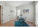 A bright office space with modern blue desk, ample natural light and a decorative world map wall hanging at 8726 Castle Cliff Dr, Matthews, NC 28105