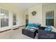 Inviting covered patio featuring comfortable seating, a coffee table, and stylish outdoor decor at 8726 Castle Cliff Dr, Matthews, NC 28105