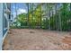 Spacious backyard, partially wooded, adjacent to the light blue siding of newly constructed home at 925 Twin Lakes Rd, Rock Hill, SC 29732