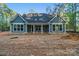 Rear exterior of new construction home showing light blue siding, white trim, and a covered patio at 925 Twin Lakes Rd, Rock Hill, SC 29732