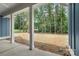 Backyard view from the covered blue patio into a grassy area surrounded by trees at 925 Twin Lakes Rd, Rock Hill, SC 29732