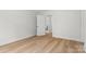 Bright bedroom featuring wood-look flooring and a door that leads to a bathroom at 925 Twin Lakes Rd, Rock Hill, SC 29732
