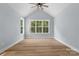 Bright bedroom with vaulted ceiling, large windows showcasing a lovely wooded view, and light hardwood floors at 925 Twin Lakes Rd, Rock Hill, SC 29732