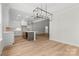 Open concept dining room, featuring modern light fixtures and hardwood floors at 925 Twin Lakes Rd, Rock Hill, SC 29732