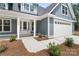 Charming exterior showcasing the front door, landscaping, and two car garage at 925 Twin Lakes Rd, Rock Hill, SC 29732