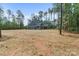 Exterior view of the home with large backyard surrounded by tall trees at 925 Twin Lakes Rd, Rock Hill, SC 29732