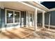 Inviting covered front porch with white columns and trim and craftsman style door with sidelight window at 925 Twin Lakes Rd, Rock Hill, SC 29732