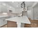 Kitchen with modern white cabinets, an island, and light backsplash at 925 Twin Lakes Rd, Rock Hill, SC 29732