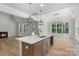 Open kitchen with an island, stainless steel appliances, modern light fixtures, and hardwood floors at 925 Twin Lakes Rd, Rock Hill, SC 29732