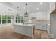 Bright open kitchen with an island, stainless steel appliances, modern light fixtures, and hardwood floors at 925 Twin Lakes Rd, Rock Hill, SC 29732