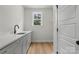 Well-lit laundry room with sleek countertops, ample cabinet space, and a window for natural light and backyard view at 925 Twin Lakes Rd, Rock Hill, SC 29732
