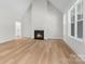 Bright living room features a cozy fireplace, natural light, and beautiful hardwood floors at 925 Twin Lakes Rd, Rock Hill, SC 29732